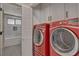 Bright laundry room with red washer and dryer at 3012 Plaza De Rosa, Las Vegas, NV 89102