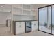 Modern wet bar with white shaker cabinets, wine rack and beverage cooler at 3012 Plaza De Rosa, Las Vegas, NV 89102