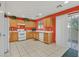 Bright kitchen features light wood cabinets, white appliances, and orange walls at 6058 Ambleshire Ave, Las Vegas, NV 89139