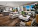 Open living area with hardwood floors and large windows at 10356 Aquila Crest Ave, Las Vegas, NV 89166
