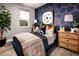 Stylish bedroom with blue accent wall and comfy bed at 10363 Vista Argento Ave, Las Vegas, NV 89166