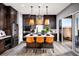 Modern kitchen with dark wood cabinets, island, and stainless steel appliances at 10363 Vista Argento Ave, Las Vegas, NV 89166