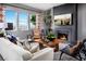 Living room with fireplace, large windows, and comfortable seating at 10363 Vista Argento Ave, Las Vegas, NV 89166