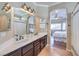 Main bathroom features double sinks, and a view of the bedroom at 1204 Oceanwood Ave, North Las Vegas, NV 89086