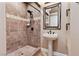 Bathroom with a walk-in shower, pedestal sink, and a framed mirror at 1206 Peach Bluff Ct, Henderson, NV 89002