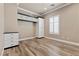 Bright bedroom with wood-look floors, built-in shelving, and large window at 1206 Peach Bluff Ct, Henderson, NV 89002