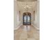 Elegant entry with double doors, chandelier, and travertine flooring at 1206 Peach Bluff Ct, Henderson, NV 89002