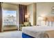 Comfortable bedroom with a king-size bed and city view at 211 E Flamingo Rd # 1018, Las Vegas, NV 89169