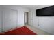 Bright bedroom with red bedding and a view of the hallway at 4132 Spring Storm Ave, North Las Vegas, NV 89081