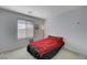 Cozy bedroom with red bedding and a window providing natural light at 4132 Spring Storm Ave, North Las Vegas, NV 89081