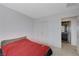Spacious bedroom with red bedding and an ensuite bathroom at 4132 Spring Storm Ave, North Las Vegas, NV 89081