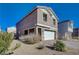 Two-story house with a white garage door and desert landscaping at 4132 Spring Storm Ave, North Las Vegas, NV 89081