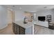 Open kitchen with granite island, gray cabinets, and stainless steel appliances at 4132 Spring Storm Ave, North Las Vegas, NV 89081