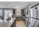 Modern kitchen with gray cabinets, granite countertops, and stainless steel appliances at 4132 Spring Storm Ave, North Las Vegas, NV 89081