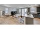 Open concept living area with kitchen, island, and neutral color palette at 4132 Spring Storm Ave, North Las Vegas, NV 89081
