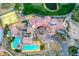 Aerial view of a community clubhouse, pool, parking, putting green, and landscaping at 42 Promenade Isle Ln, Henderson, NV 89011