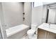 Contemporary bathroom with tiled walls, built-in shelving, bathtub, and modern vanity with sink at 42 Promenade Isle Ln, Henderson, NV 89011