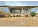 View of backyard showing covered patio and potential for landscaping with mature tree at 2510 N Woodchips Rd, Pahrump, NV 89060