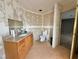 Bathroom featuring a wooden vanity, granite countertop, toilet, and partially finished walls at 2510 N Woodchips Rd, Pahrump, NV 89060