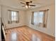 Bedroom with linoleum flooring, ceiling fan, and windows overlooking the outdoor scenery at 2510 N Woodchips Rd, Pahrump, NV 89060