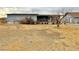 Exterior of home with a dry yard and a detached garage in background at 2510 N Woodchips Rd, Pahrump, NV 89060