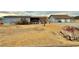 Exterior view of property showing detached garage and rustic landscaping on a spacious lot at 2510 N Woodchips Rd, Pahrump, NV 89060