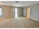 Bright living room features plush carpeting, neutral walls, and natural light at 2510 N Woodchips Rd, Pahrump, NV 89060