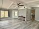 Inviting living room features light gray walls, wood-look floors, ceiling fan, and a decorative console table at 2510 N Woodchips Rd, Pahrump, NV 89060