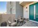 Inviting front patio with teal door and two armchairs at 4294 Eagle Summit Ave # 0, Las Vegas, NV 89141