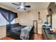 Cozy bedroom with a double bed, guitar, and ceiling fan at 4690 E Utah Ave, Las Vegas, NV 89104