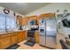 Kitchen boasts wood cabinets and stainless steel appliances at 4690 E Utah Ave, Las Vegas, NV 89104