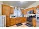 Kitchen with wood cabinets, stainless steel appliances, and a microwave at 4690 E Utah Ave, Las Vegas, NV 89104