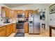 Kitchen with wood cabinets, stainless steel appliances, and a microwave at 4690 E Utah Ave, Las Vegas, NV 89104