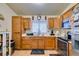 Kitchen with wooden cabinets, a double sink, and a microwave at 4690 E Utah Ave, Las Vegas, NV 89104