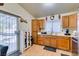 Kitchen with wood cabinets, a double sink, and access to the backyard at 4690 E Utah Ave, Las Vegas, NV 89104