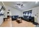 Living room with hardwood floors, leather sofas, and a view into the dining area at 4690 E Utah Ave, Las Vegas, NV 89104