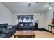 Living room with hardwood floors, leather sofas, and a ceiling fan at 4690 E Utah Ave, Las Vegas, NV 89104