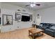 Spacious living room featuring a large TV, leather sofa, and coffee table at 4690 E Utah Ave, Las Vegas, NV 89104