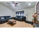 Living room with hardwood floors, leather sofas, and a ceiling fan at 4690 E Utah Ave, Las Vegas, NV 89104