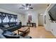 Bright living room with hardwood floors, leather sofas, and a ceiling fan at 4690 E Utah Ave, Las Vegas, NV 89104