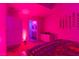 Bedroom with pink lighting and bathroom access at 150 Las Vegas Blvd # 814, Las Vegas, NV 89101