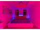 Bedroom with vibrant colored lighting and a large bed at 150 Las Vegas Blvd # 814, Las Vegas, NV 89101