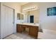 Well-lit bathroom with dual sinks, ample counter space, and a decorative mirror at 3456 Beca Faith Dr, North Las Vegas, NV 89032