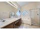 Bathroom with double vanity, soaking tub, and glass shower at 3456 Beca Faith Dr, North Las Vegas, NV 89032