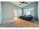 Primary bedroom with ceiling fan, carpet, and en-suite bathroom at 3456 Beca Faith Dr, North Las Vegas, NV 89032