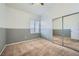 Well-lit bedroom featuring mirrored closet doors at 3456 Beca Faith Dr, North Las Vegas, NV 89032