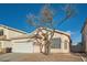 Single-story house with a white garage door and landscaped front yard at 3456 Beca Faith Dr, North Las Vegas, NV 89032