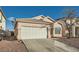 Front view of a single-story house with a garage and gravel driveway at 3456 Beca Faith Dr, North Las Vegas, NV 89032