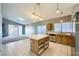 Kitchen with light wood cabinets, stainless steel appliances, and an island at 3456 Beca Faith Dr, North Las Vegas, NV 89032