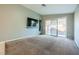 Living room with carpet, sliding glass doors, and built-in shelving at 3456 Beca Faith Dr, North Las Vegas, NV 89032